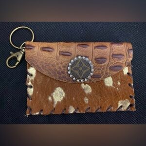 Brown and gold envelope wristlet.